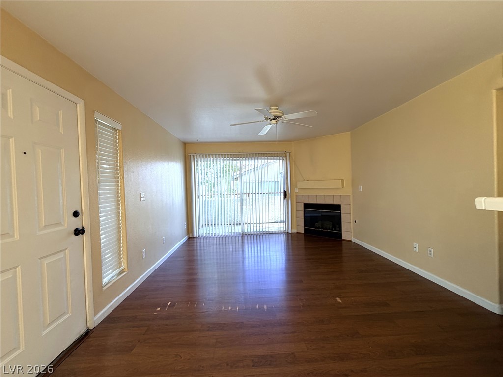4955 South Lindell Road, Unit 203 Las Vegas, NV 89118 - Photo 6 of 31 Rich hardwood flooring leads to an inviting fireplace, anchoring this comfortable living space.