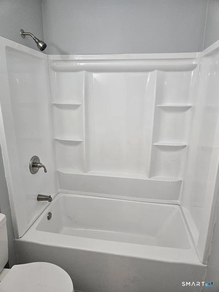 88 Walnut Street East Hartford, CT 06108 - Photo 6 of 8 a bathroom with a toilet and a bath tub
