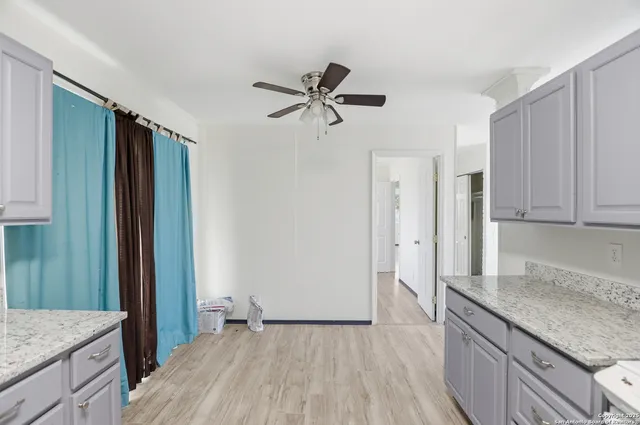 a view of a kitchen with a sink and dishwasher refrigerator freezer