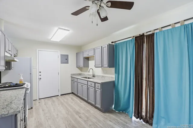 a kitchen with kitchen island cabinets and wooden floor