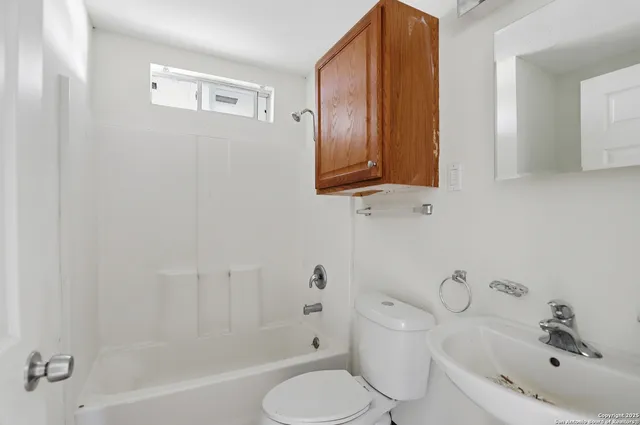 a bathroom with a sink a toilet and bathtub