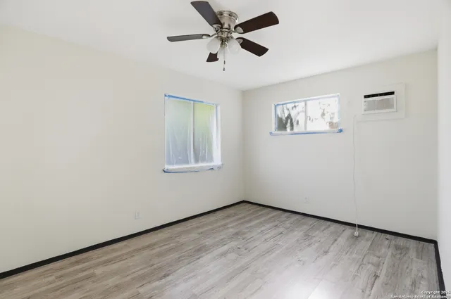 wooden floor in an empty room with a window