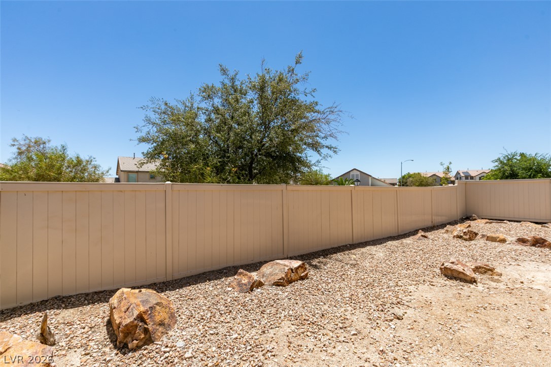 5150 Riverside Run Court North Las Vegas, NV 89081 - Photo 47 of 50 Secure yard featuring robust fencing and drought-resistant landscaping.