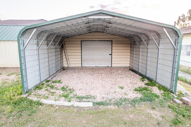 634 South 2100th Street West Vernal, UT 84078 - Photo 59 of 71 Metal carport structure with a green trim, providing covered parking