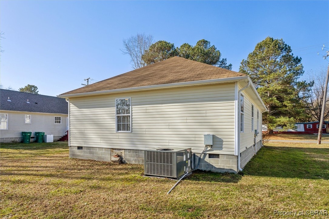 111 Pleasant Spring Avenue Waverly, VA 23890 - Photo 29 of 32 View of home's exterior with a yard and central air condition unit