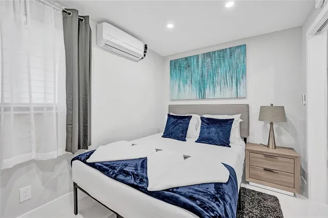 a bed sitting in a bedroom next to a window