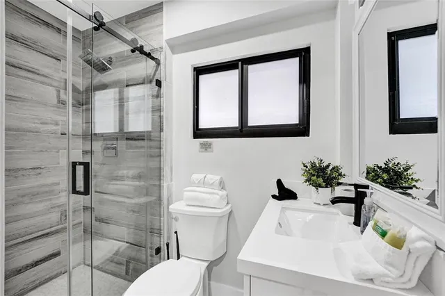 a bathroom with a sink toilet and shower