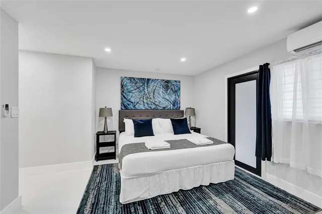 a bed room with a bed and a large mirror