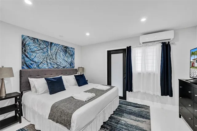 a bedroom with a large bed and a couch