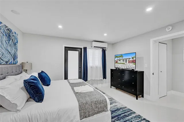 a bedroom with a bed and dresser