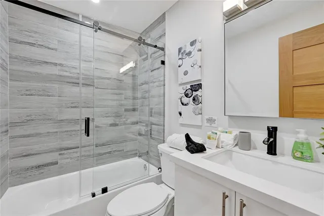 a bathroom with a sink toilet and shower