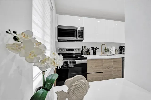 a kitchen with a sink a stove and cabinets