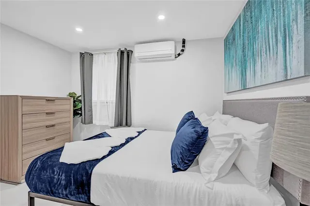 a bedroom with a bed and a dresser