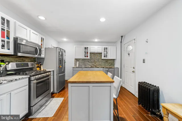 a kitchen with stainless steel appliances granite countertop a sink and a stove
