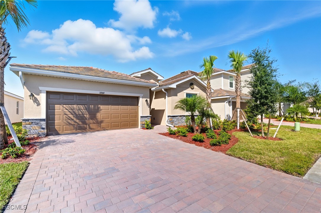 a front view of a house with a yard and garage
