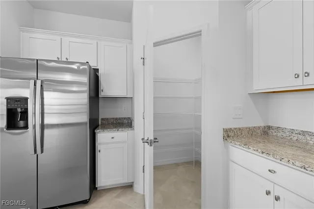 a kitchen with a refrigerator and cabinets