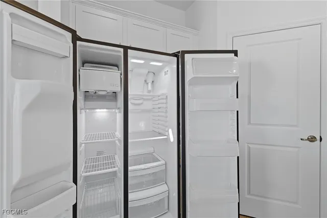 an empty room with a window and a ceiling fan