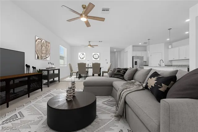 a living room with furniture a large window and a flat screen tv