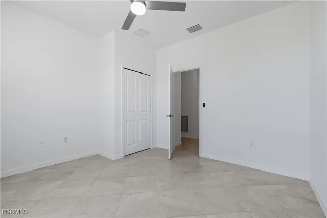 a bathroom with a granite countertop sink toilet mirror and bathtub