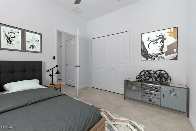 a bedroom with a bed a flat screen tv and a couch