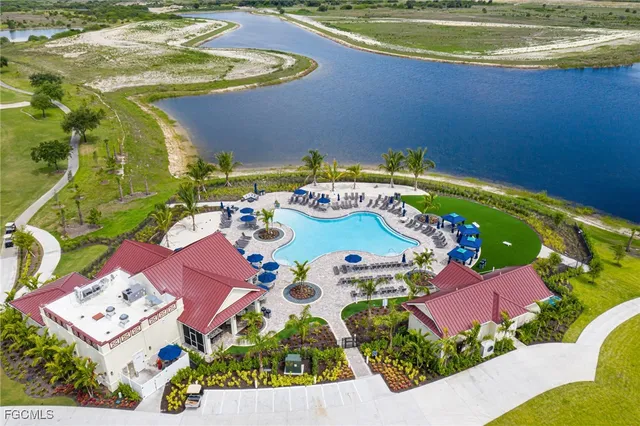 an aerial view of a house a yard swimming pool and outdoor seating