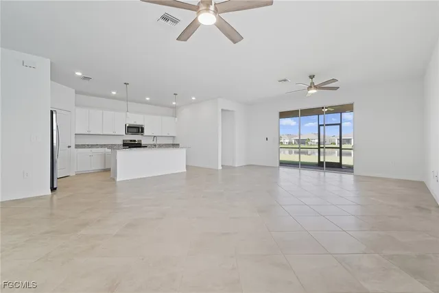 a view of a kitchen with a sink and a refrigerator
