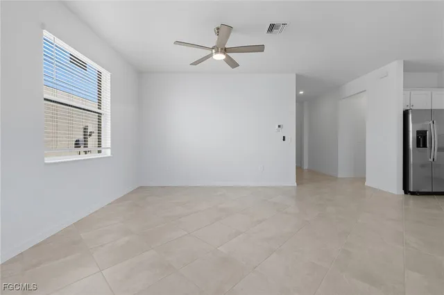 a view of an empty room with a ceiling fan
