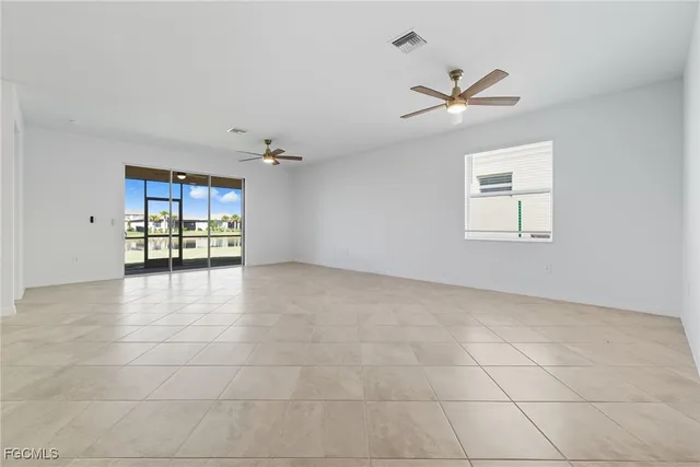 a view of an empty room with a ceiling fan