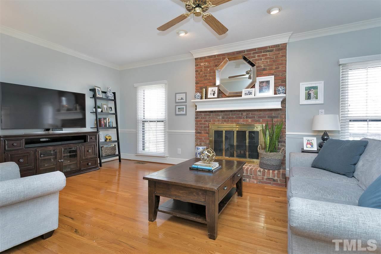 4132 Betterton Drive Raleigh, NC 27613 - Photo 8 of 28 a living room with furniture and a fireplace
