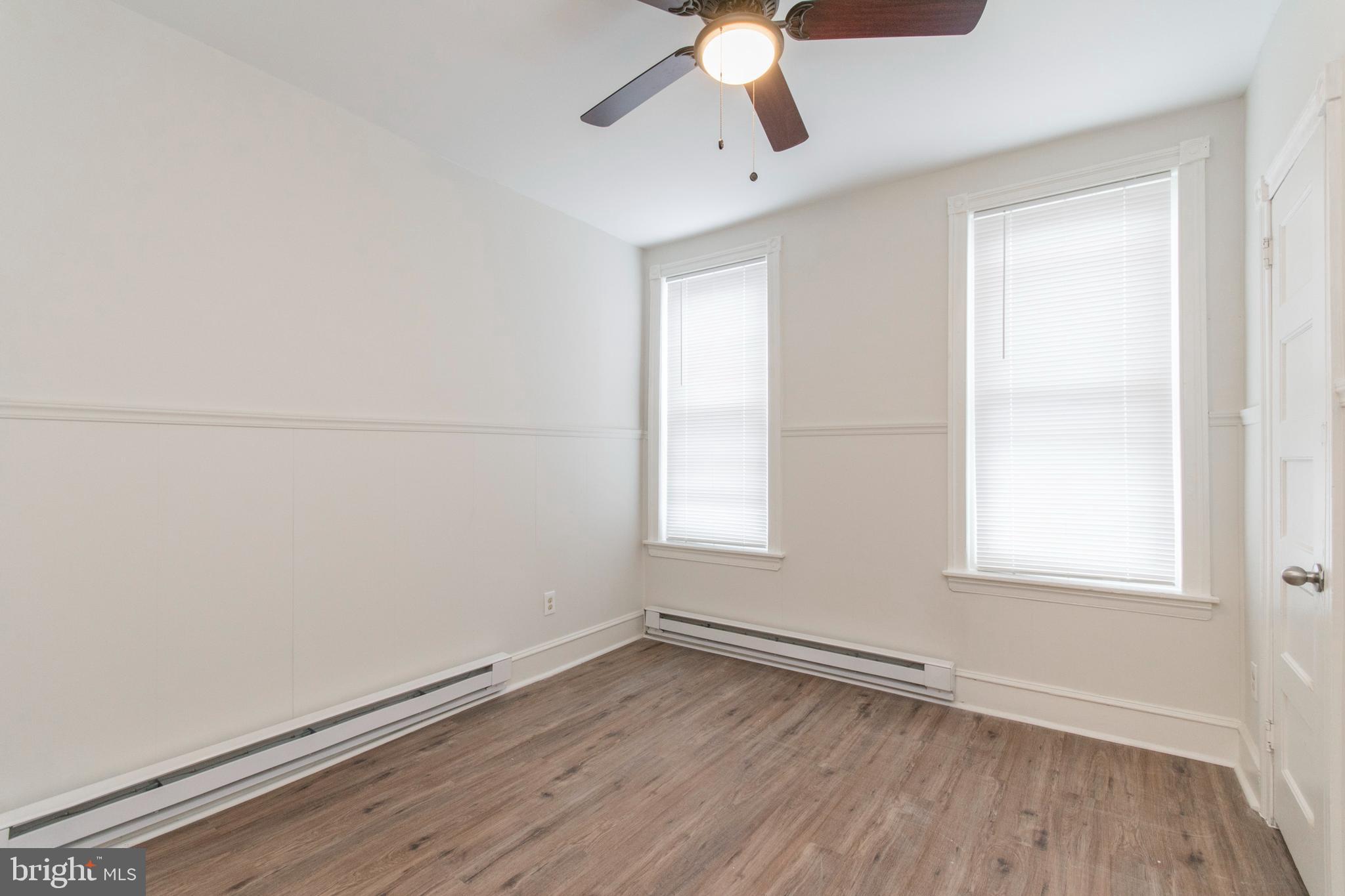 725 West Luzerne Street Philadelphia, PA 19140 - Photo 11 of 23 an empty room with a window and wooden floor