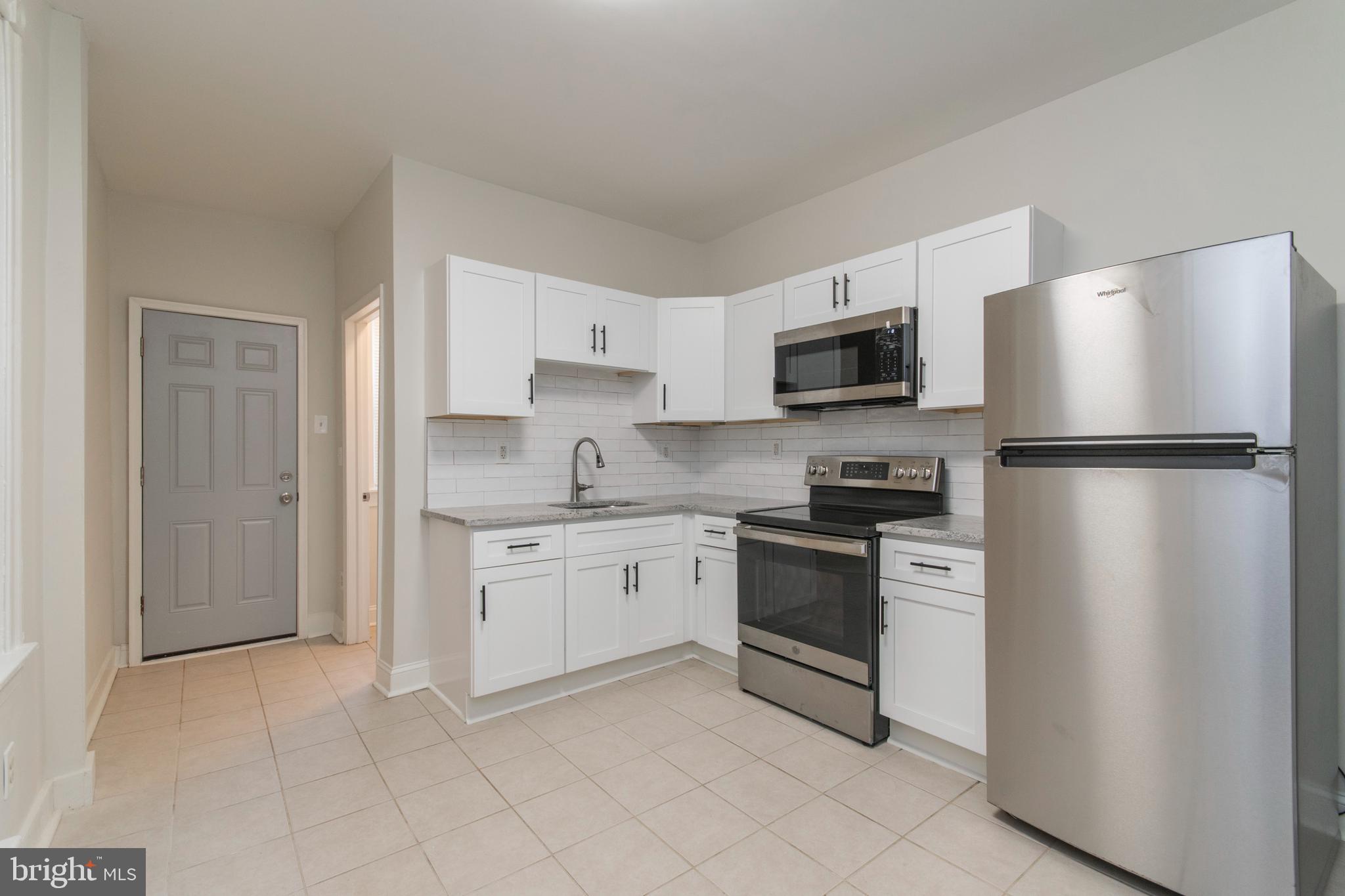 725 West Luzerne Street Philadelphia, PA 19140 - Photo 6 of 23 a kitchen with stainless steel appliances granite countertop a refrigerator stove a sink and dishwasher
