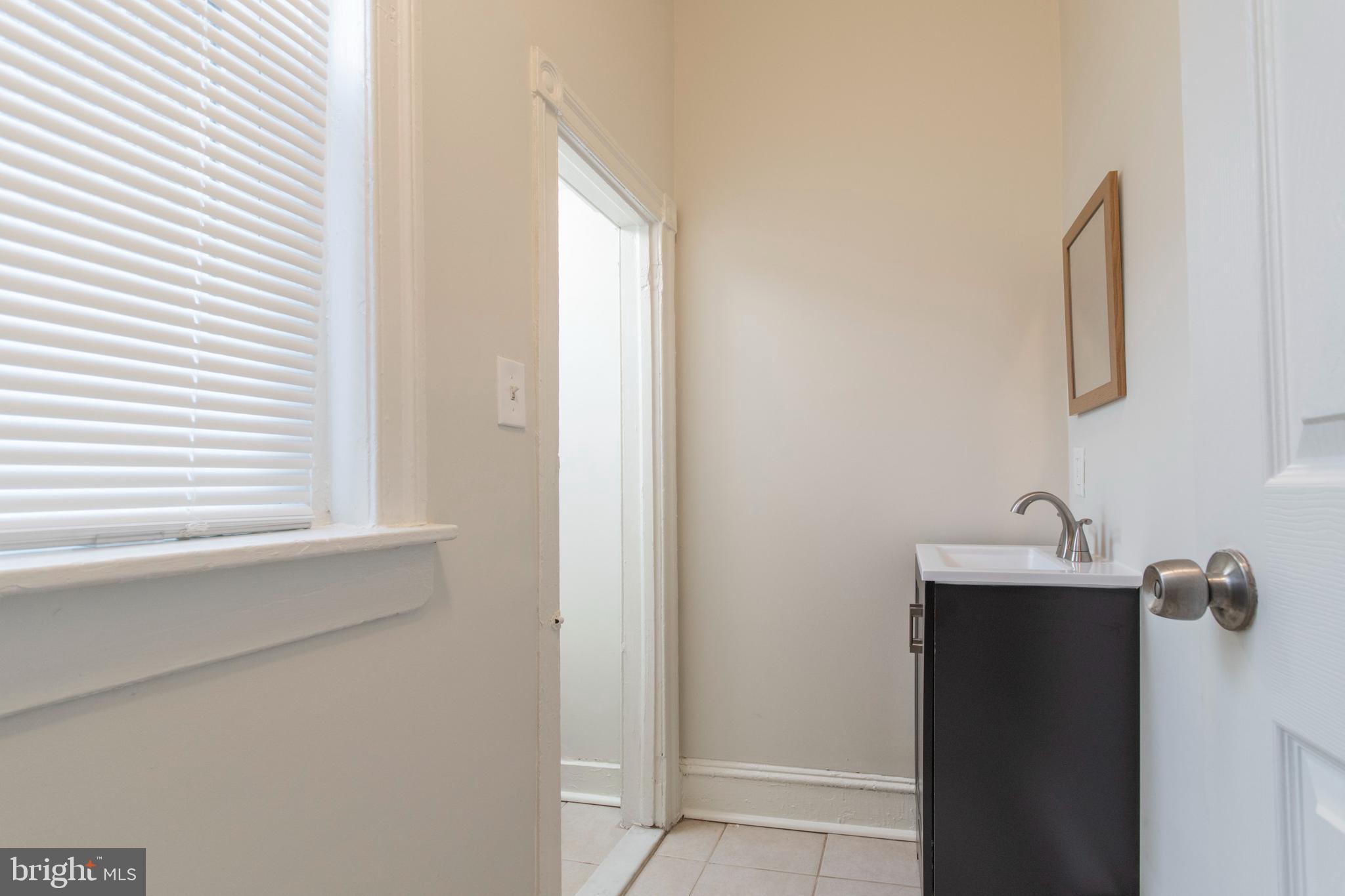 725 West Luzerne Street Philadelphia, PA 19140 - Photo 10 of 23 a bathroom with a sink and a mirror
