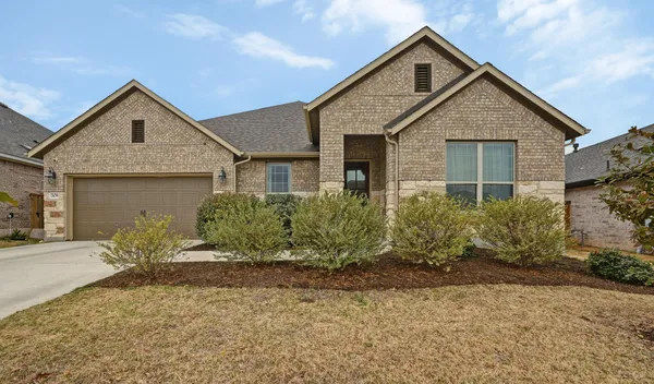 a view of a house with a yard and plants