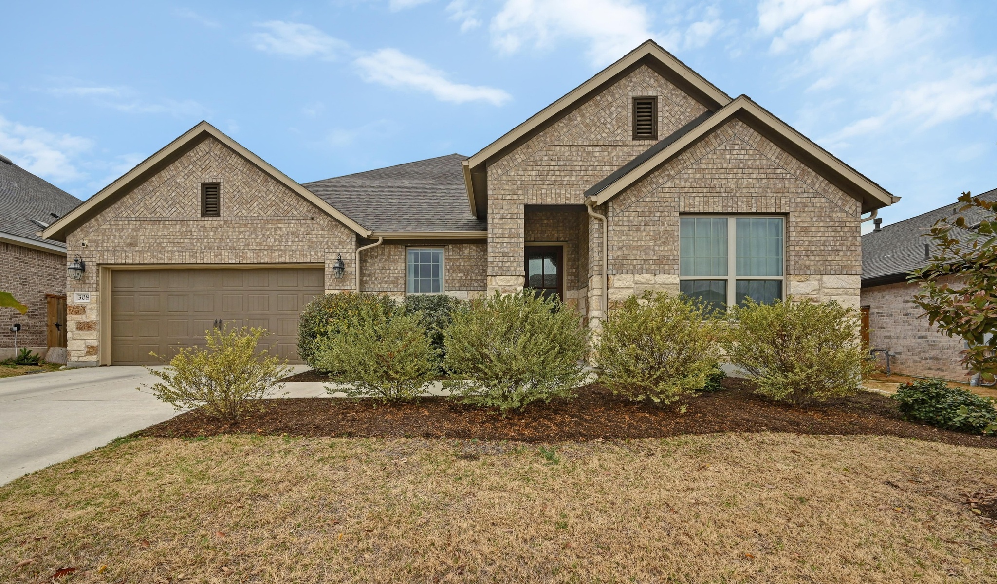 a view of a house with a yard and plants