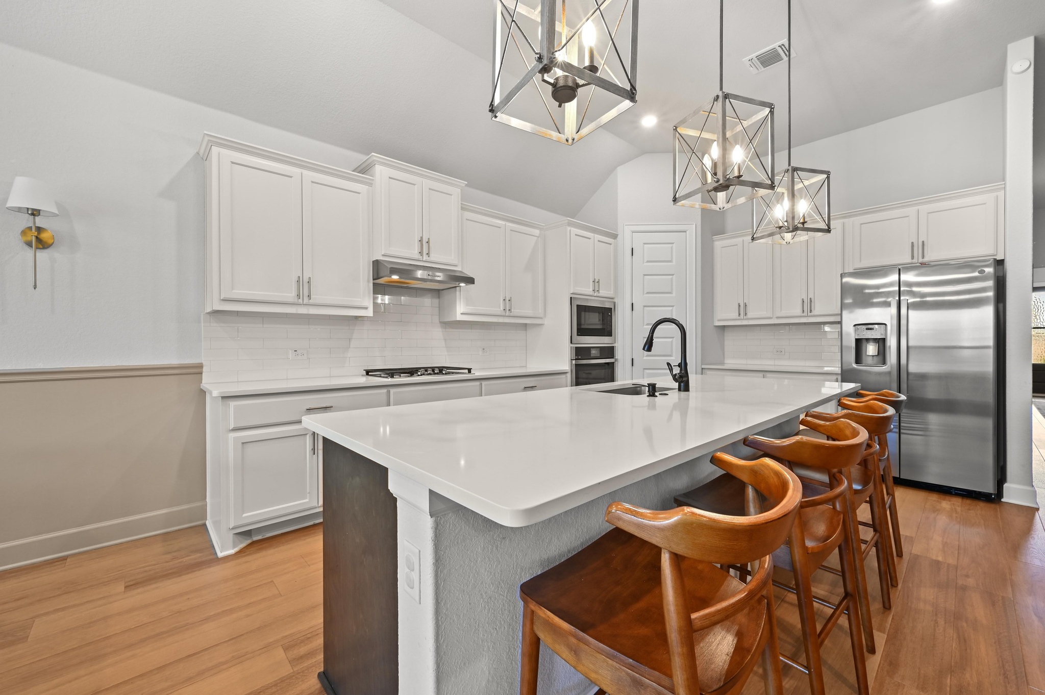 308 Allegheny Way Kyle, TX 78640 - Photo 12 of 40 a kitchen with stainless steel appliances granite countertop a sink a stove a refrigerator cabinets and chairs