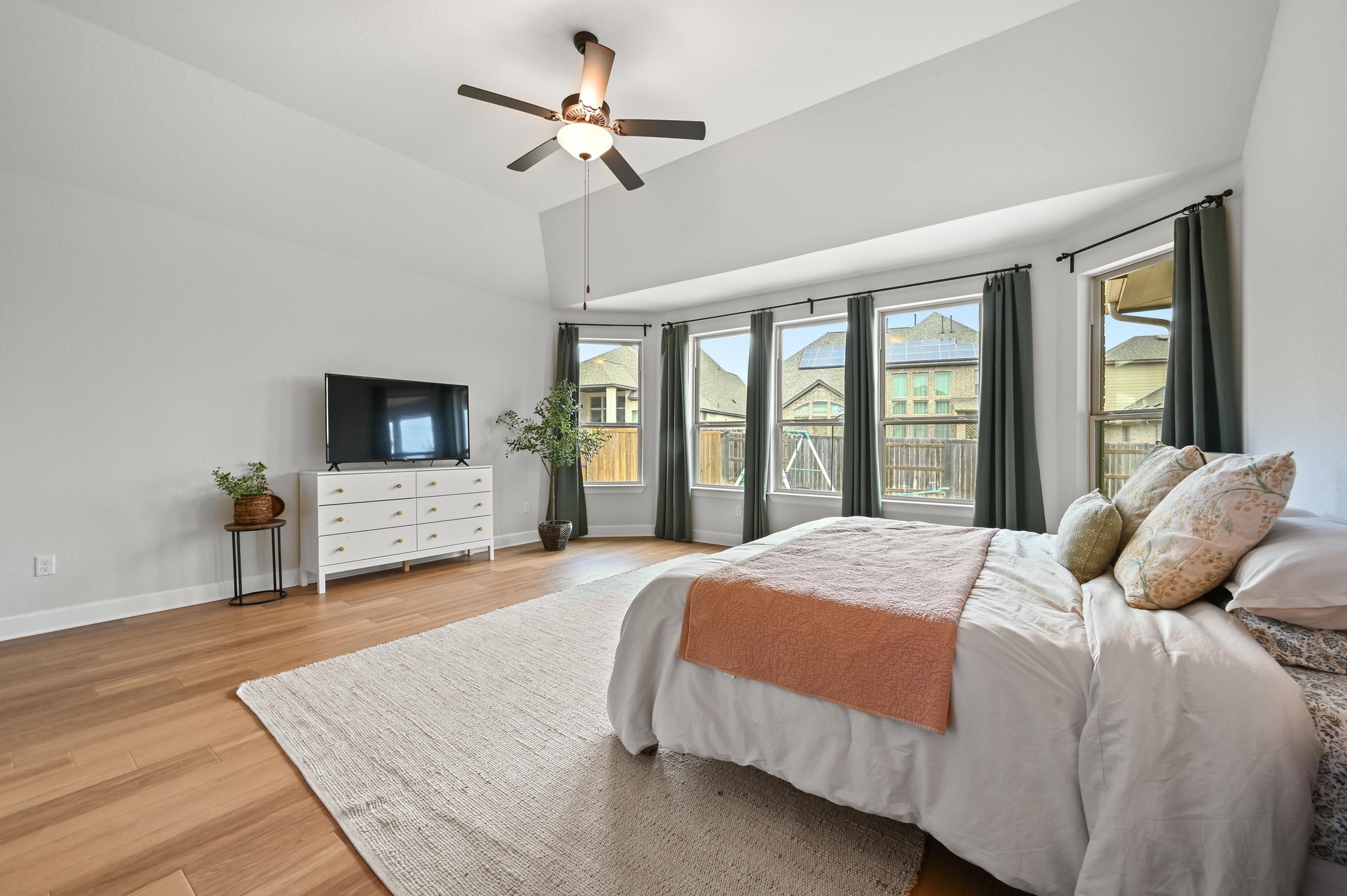 308 Allegheny Way Kyle, TX 78640 - Photo 15 of 40 a bedroom with a large bed a flat tv screen and a dresser