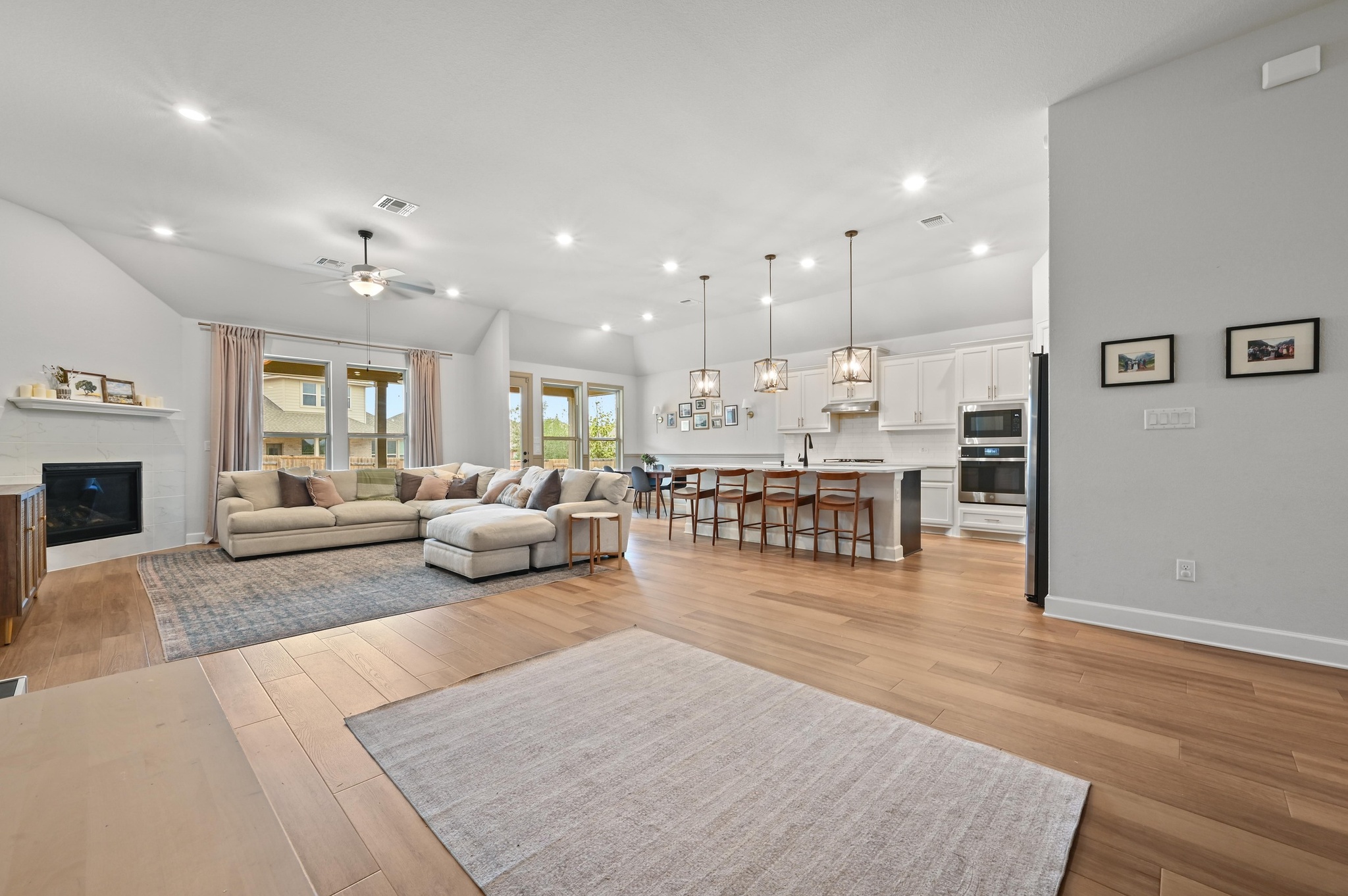 308 Allegheny Way Kyle, TX 78640 - Photo 8 of 40 a living room with furniture and a dining table with wooden floor