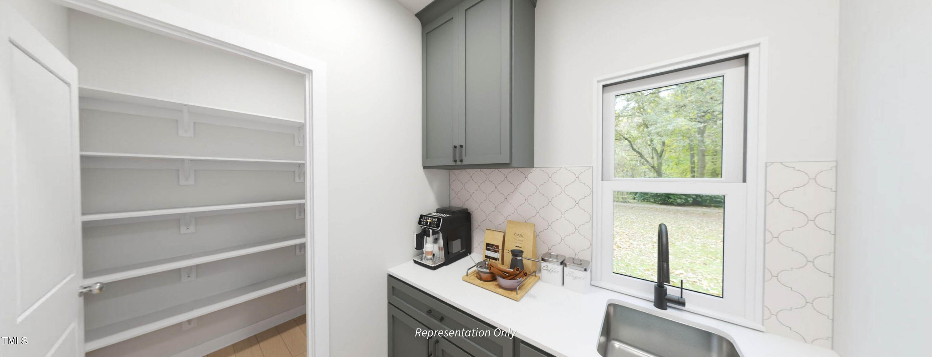 8733 Maxine Street Willow Spring, NC 27592 - Photo 9 of 34 a kitchen with a sink cabinets and a window