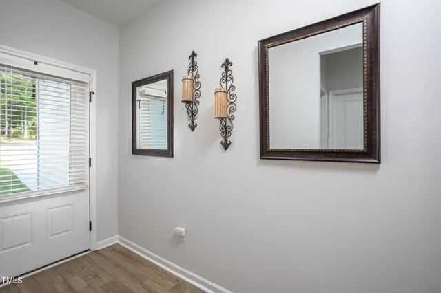 a view of empty room with wooden floor and cabinet