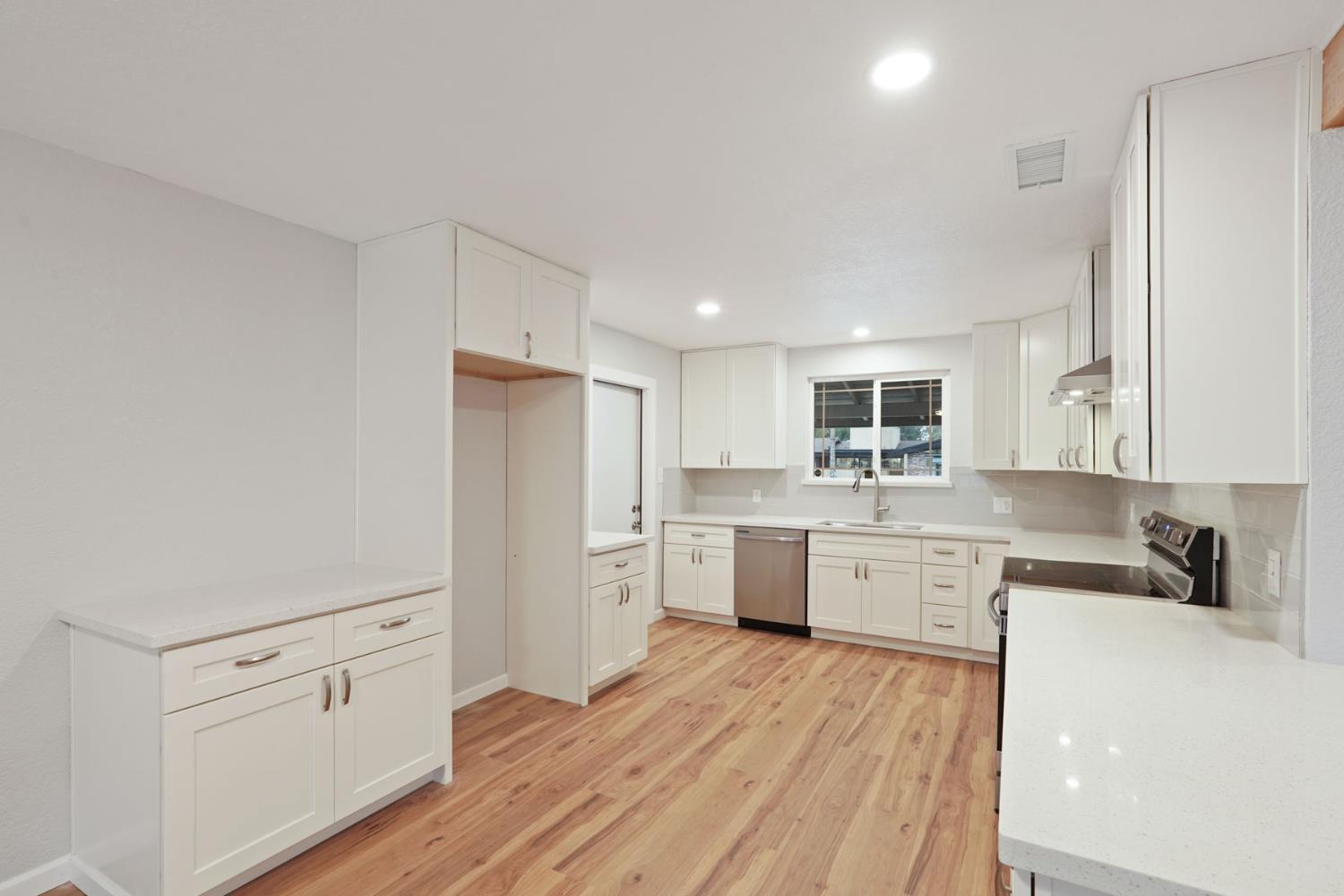 322 West Turner Road Lodi, CA 95240 - Photo 11 of 16 a kitchen with white cabinets appliances and sink