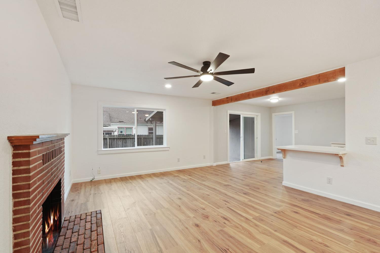 322 West Turner Road Lodi, CA 95240 - Photo 6 of 16 a view of an empty room with wooden floor and a window