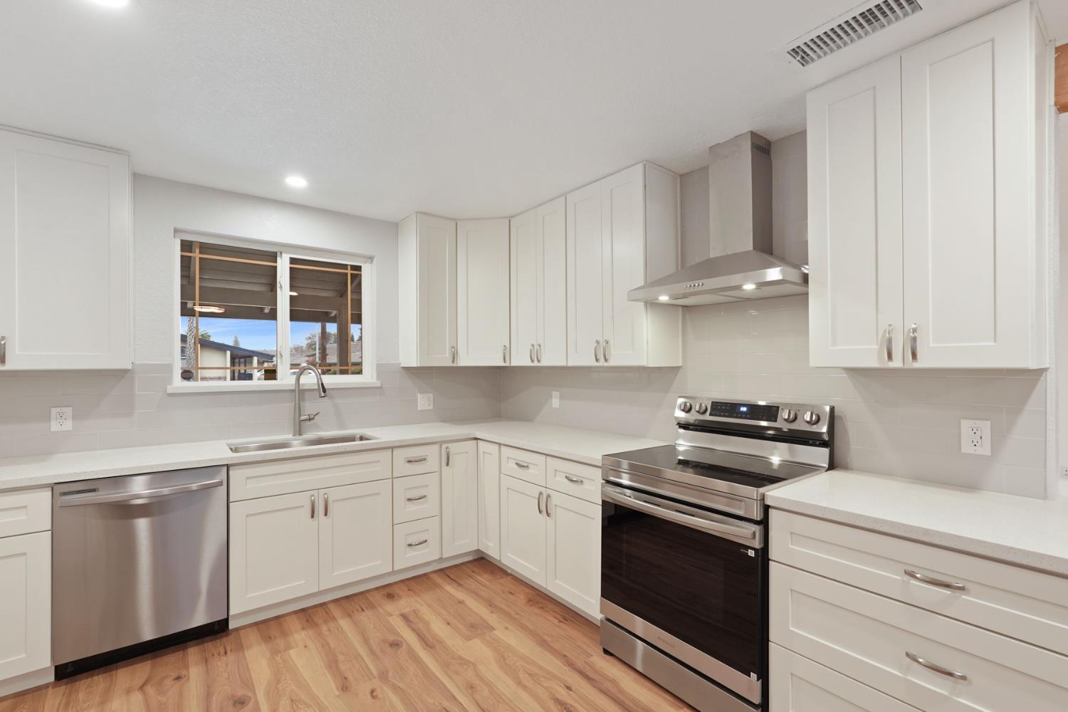 322 West Turner Road Lodi, CA 95240 - Photo 8 of 16 a kitchen with a sink stove and cabinets