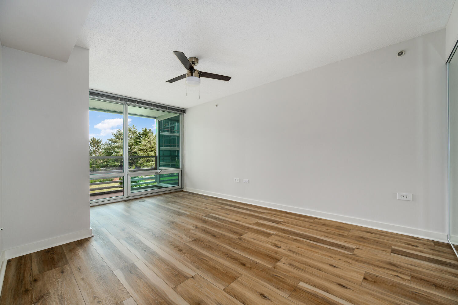 9655 Woods Drive, Unit 507 Skokie, IL 60077 - Photo 14 of 27 a view of room with wooden floor and windows