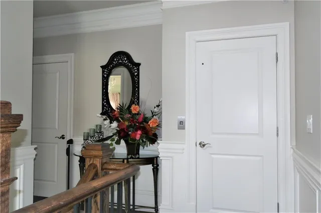 a view of a hallway with wooden floor and entryway