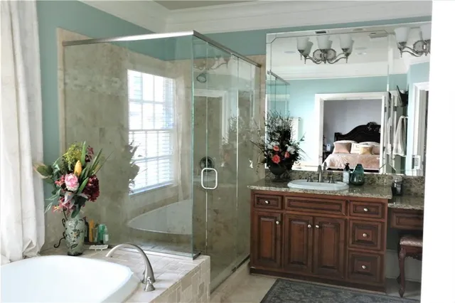 a bathroom with a granite countertop sink a mirror and a shower