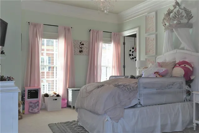 a bedroom with a bed and windows