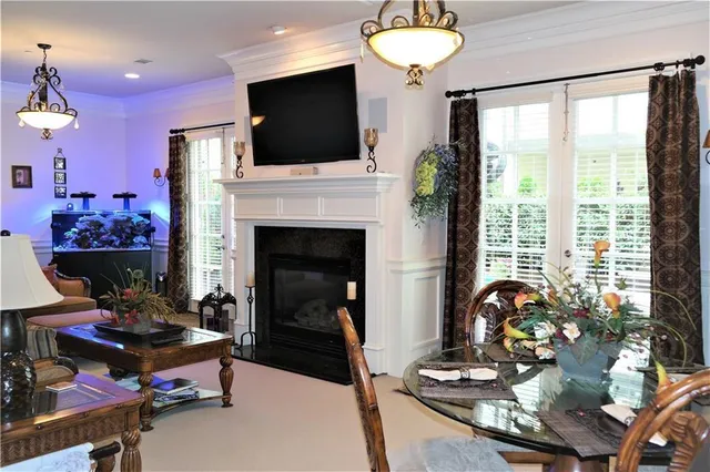 a living room with furniture a flat screen tv and a fireplace