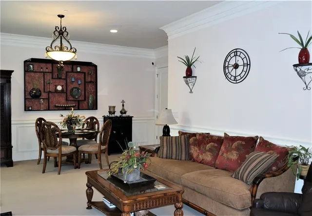 a living room with furniture a rug and a chandelier