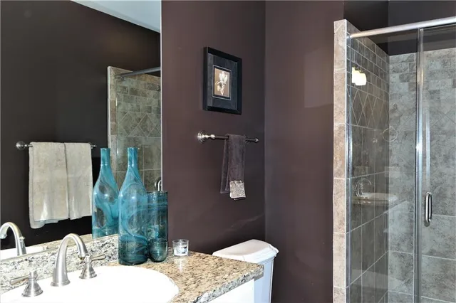 a bathroom with a sink vanity and shower