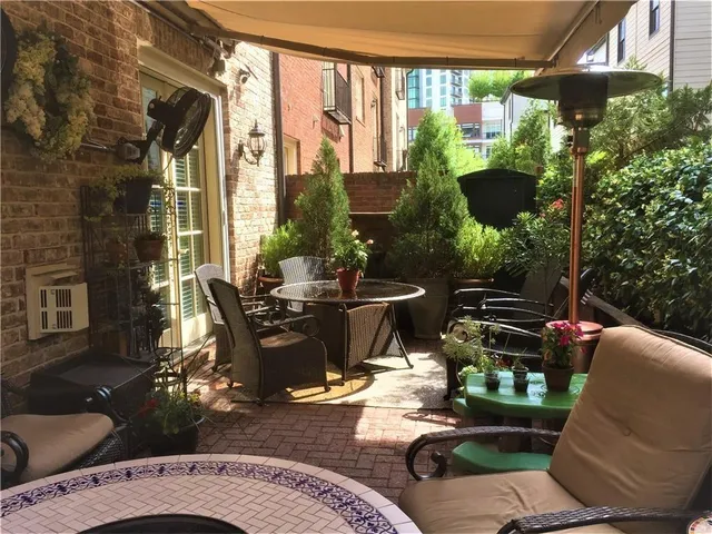a view of a patio with table and chairs and potted plants